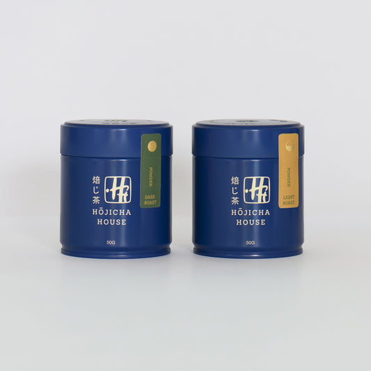 Two blue tea canisters with 'Hojicha House' branding on a white background
