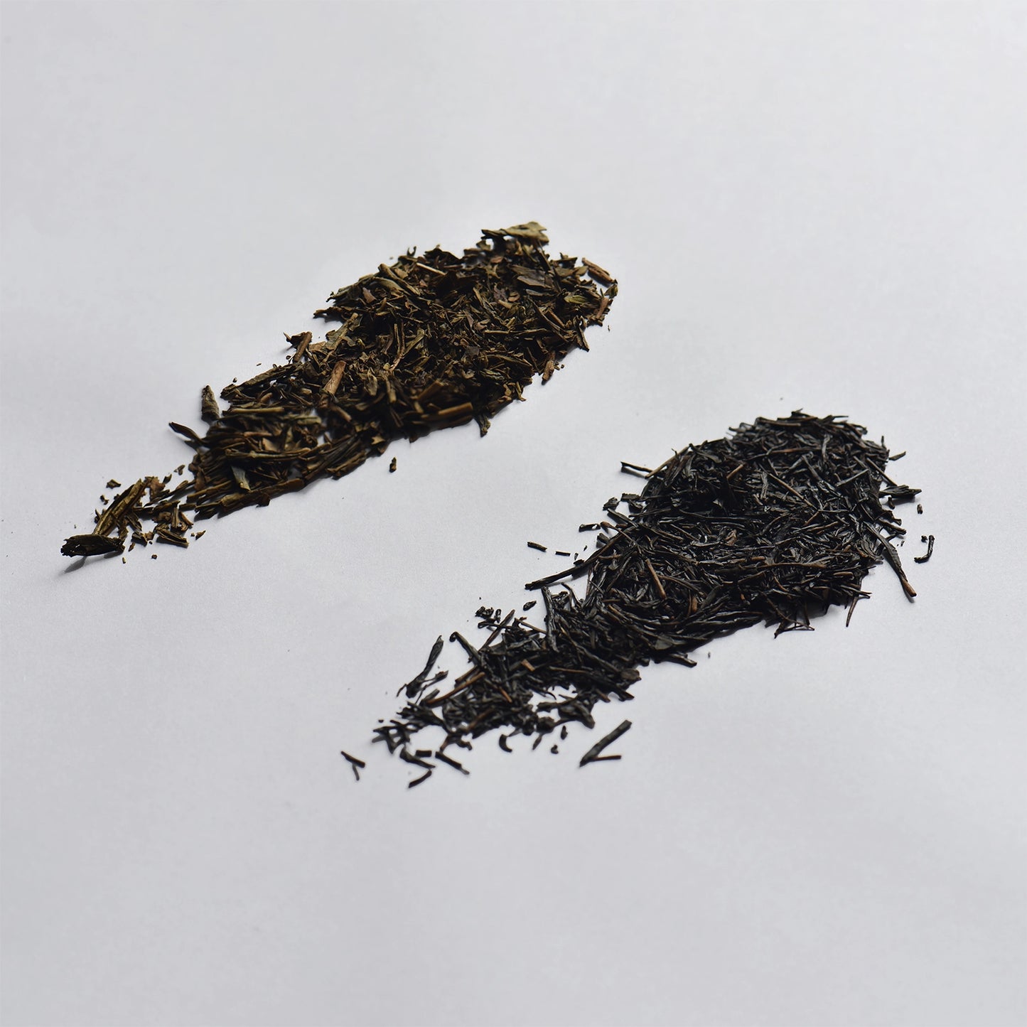 Close up of tea leaves shown on a white background